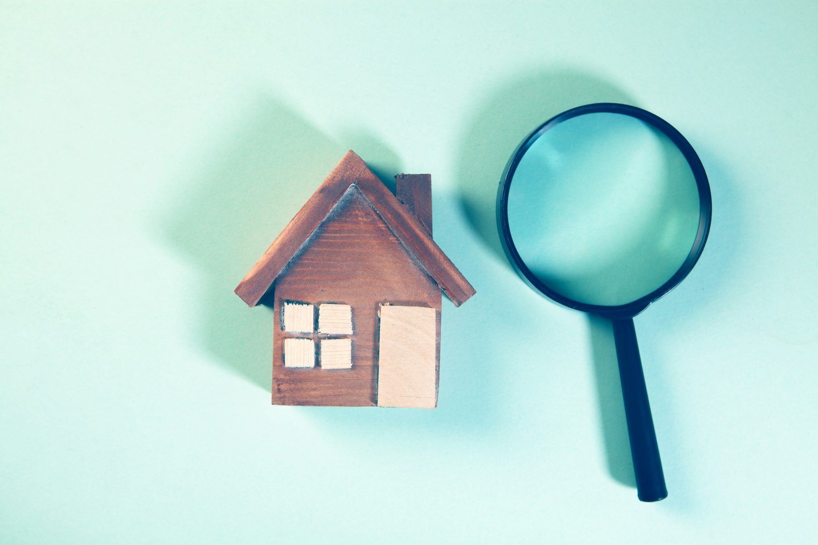 Magnifying glass over a model house